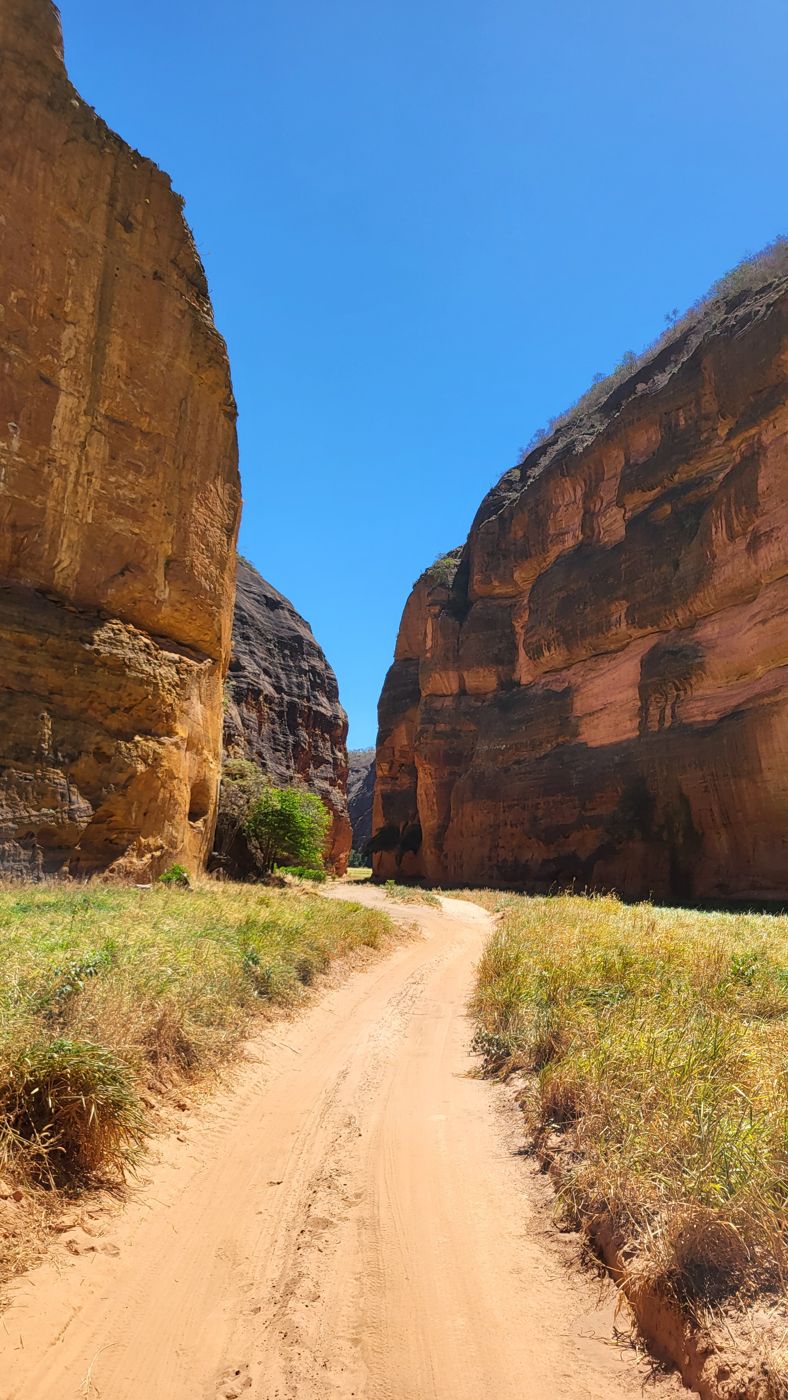 Looking up at the narrow canyon walls of Cânions do Viana, dirt path below