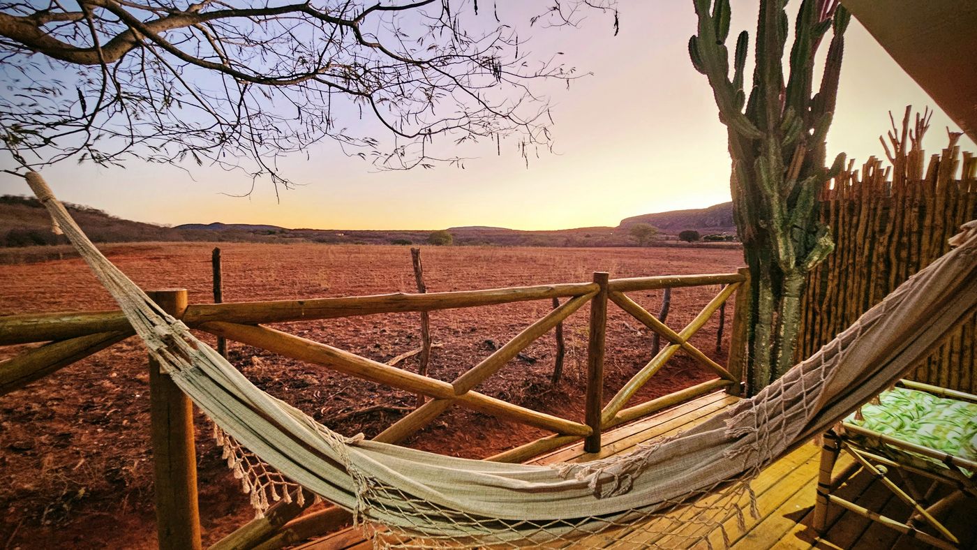 Hammock strung between trees at sunset, Sertão do Luar deck