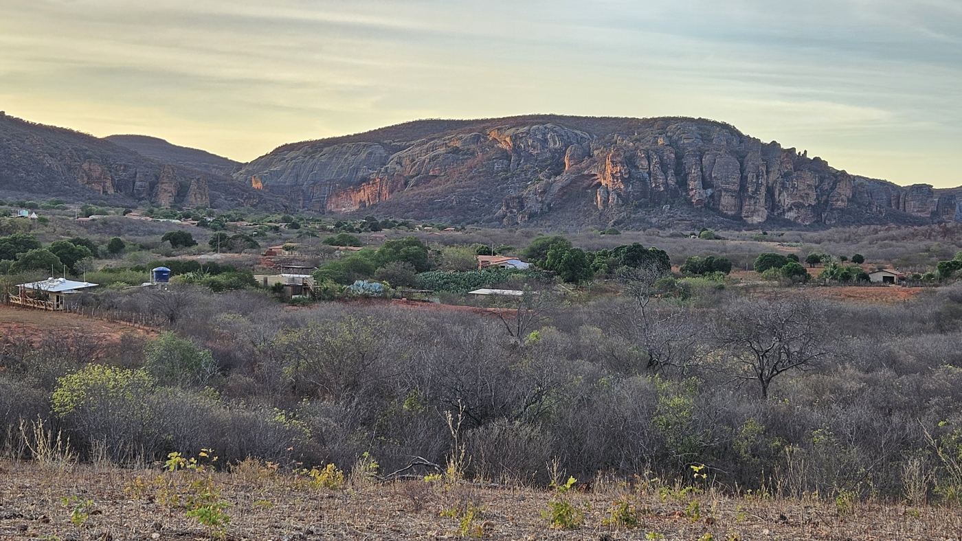 Sunset over the sertão hills near Coronel José Dias, rocky outcrops and scattered houses below